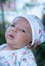 Portrait of a newborn baby infant hold close by mother in the garden, close up. Family