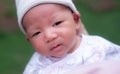 Portrait of a newborn baby infant hold close by mother in the garden, close up. Family