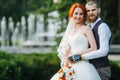 Portrait of the newly wed couple standing together in the park