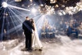 Portrait of newlyweds first wedding dance. Just married couple dancing in darkness. Groom holds bride& x27;s hand dancing Royalty Free Stock Photo