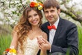 Portrait newlyweds in the lush spring garden