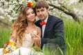 Portrait newlyweds in the lush spring garden