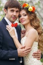 Portrait newlyweds in the lush spring garden