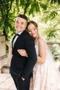 Portrait of newlyweds stand on balcony and dreaming. Handsome groom and beautiful bride on their wedding day Royalty Free Stock Photo