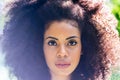 Portrait of nice afro girl in a garden. Close up.