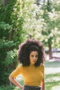 Portrait of nice afro girl in a garden. Mid shot.