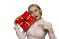 Portrait of nice attractive amazed girl with red gift present isolated white background.