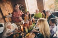 Portrait of nice attractive cheerful family brother sister parents grandparents enjoying festal homemade meal cutting Royalty Free Stock Photo