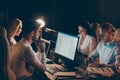 Portrait of nice attractive focused coworkers meeting preparing month annual report researching data analysing at night