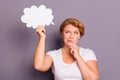 Portrait of nice attractive sad wavy-haired lady in casual white t-shirt holding in hand cloud figure thinking creating