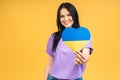 Portrait of nice beautiful lovely glad cheerful woman holding in hands Ukrainian flag having fun isolated over yellow pastel color Royalty Free Stock Photo