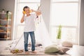 Portrait of nice cheerful cute little boy dancing listening music wear white shirt light modern room interior design Royalty Free Stock Photo