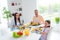 Portrait of nice friendly family parents daughter spend pastime prepare eat tasty domestic food dining room flat inside