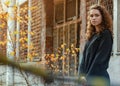 Portrait of a nice girl with curly hair in a dark jacket