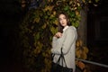 Portrait of a nice girl in a warm coat in a night city. Brunet girl and night city Royalty Free Stock Photo