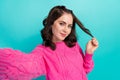 Portrait of nice gorgeous woman with wavy hairdo dressed pink sweater doing selfie hold curl isolated on turquoise color