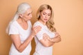 Portrait of nice-looking attractive gloomy grumpy moody ladies wearing white outfit granny mom supporting grandchild Royalty Free Stock Photo