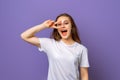 Portrait of nice-looking optimistic teen girl showing v-sign near eye, standing over purple background. Young emotional woman in Royalty Free Stock Photo