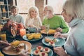 Portrait of nice lovely cheerful cheery glad friendly big full family enjoying eating domestic brunch lunch delicious