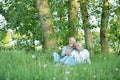 Portrait of nice mature couple sitting on green grass Royalty Free Stock Photo