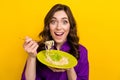 Portrait of nice overjoyed astonished girl hand hold noodles pasta fork plate isolated on yellow color background