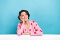 Portrait of nice thoughtful girl touch cheek looking empty space dreaming folded hands over whiteboard isolated on blue Royalty Free Stock Photo