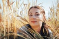 Portrait of woman on a field full of yellow ears Royalty Free Stock Photo