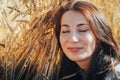 Portrait of woman on a field full of yellow ears Royalty Free Stock Photo