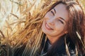 Portrait of woman on a field full of yellow ears Royalty Free Stock Photo