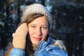 Portrait of the nice young woman in the blue jacket and a cap Royalty Free Stock Photo