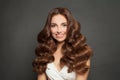 Portrait of nice young woman brunette with healthy skin, natural makeup and wavy brown hair on black background Royalty Free Stock Photo