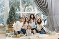 Portrait of noel large family gathering. One big stylish family. Grey-haired grandparents, granddaughter, grandson