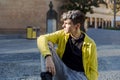 Portrait of a non binary person looking at camera while posing outdoors.