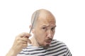 Caucasian bald man and comb Royalty Free Stock Photo