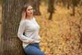 Nostalgic young woman walking in a autumn park