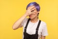 Portrait of nosy wondered hipster girl looking through fingers with suspicious prying eyes. studio shot Royalty Free Stock Photo