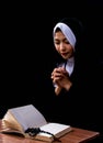 Portrait of nun praying and reading scripture Royalty Free Stock Photo