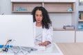 Portrait of a nurse female physician typing a medical report on her computer in the lobby