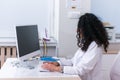 Portrait of a nurse female physician typing a medical report on her computer in the lobby