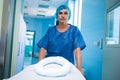 Portrait of nurse pushing empty stretcher