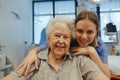 Portrait of nurse and senior patient talking in hospital corridor. Emotional support for elderly woman.