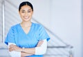 Portrait, nurse and woman with arms crossed, smile and career with healthcare, surgeon and expert in a hospital. Person