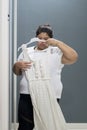 Unhappy obese woman trying her old dress
