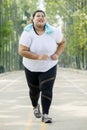 Obese woman running on the road Royalty Free Stock Photo