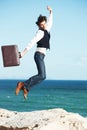 Portrait, ocean and jump with man, briefcase and achievement with happiness, celebration and business. Person, employee Royalty Free Stock Photo