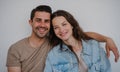 Portrait od happy young couple hugging and looking at camera, on white background. Royalty Free Stock Photo