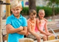 Portrait of offended boy which is standing outside of the company Royalty Free Stock Photo