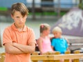 Portrait of offended boy which is standing outside of the company Royalty Free Stock Photo