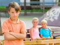 Portrait of offended boy which is standing outside of the company Royalty Free Stock Photo