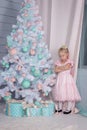 Portrait of an offended and frustrated European little blonde Princess girl with a crown in a beautiful dress sitting on the floor Royalty Free Stock Photo